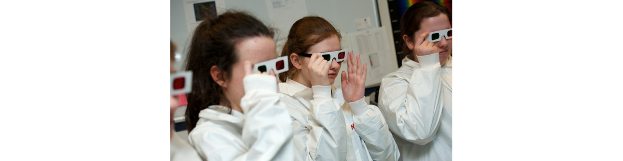 School children wearing 3D glasses and lab coats.